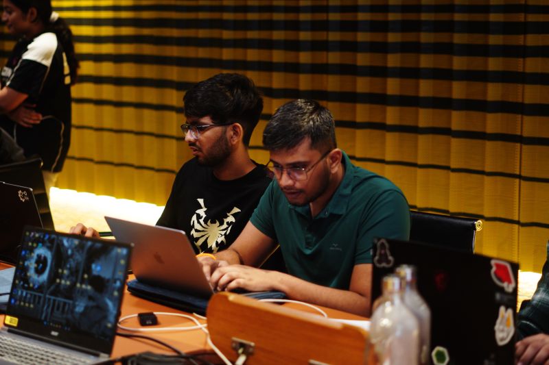 Participants collaborating on laptops during The Void build sprint