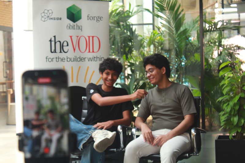 A conversation at The Void, with the event and host banner behind the speakers